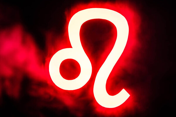 red illuminated Leo zodiac sign with smoke on background