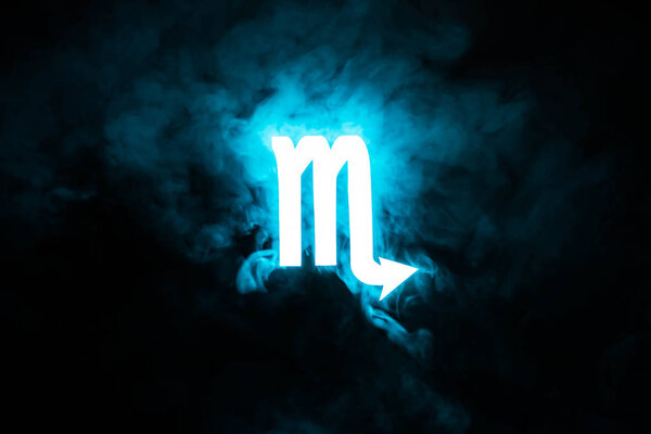 blue illuminated Scorpio zodiac sign with smoke on background