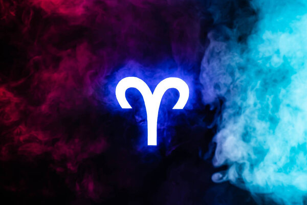 blue illuminated Aries zodiac sign with colorful smoke on background