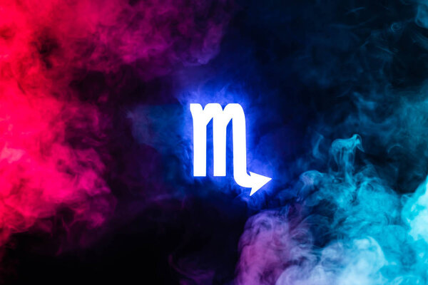blue illuminated Scorpio zodiac sign with colorful smoke on background
