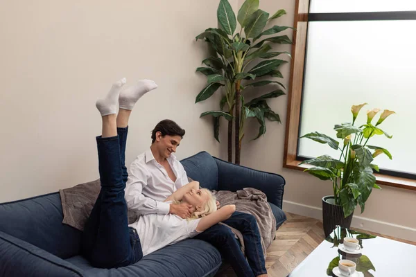 Smiling Girl Lying Boyfriend Lap Sofa Living Room — Stock Photo, Image