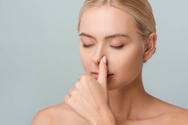 attractive naked woman touching nose isolated on grey  clipart
