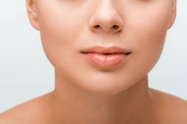 cropped view of young woman with lip gloss on lips isolated on white 