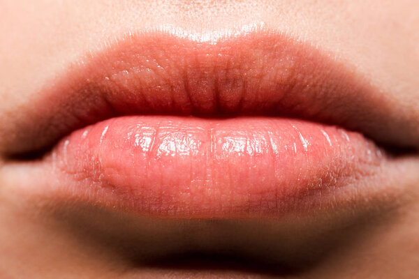 cropped view of shiny lips with lip gloss 