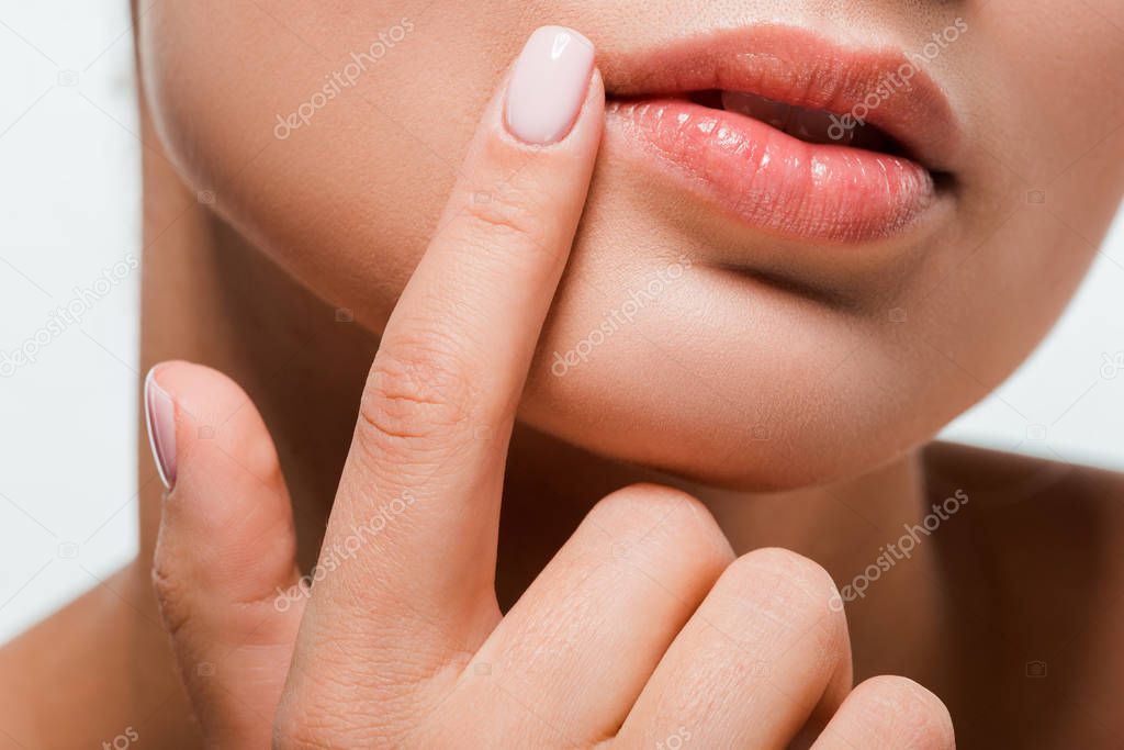 cropped view of woman pointing with finger at face isolated on white 