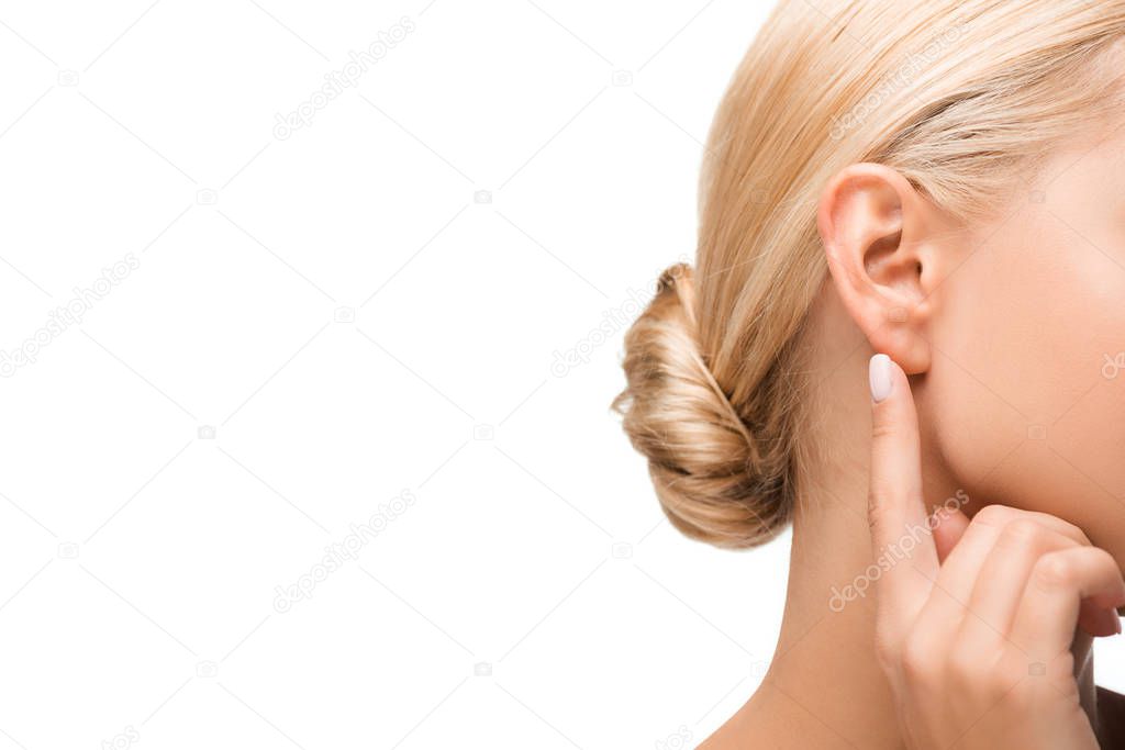 cropped view of blonde girl pointing with finger at ear isolated on white 
