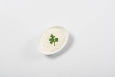 Top view of tzatziki sauce in bowl on white background clipart