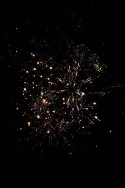 traditional orange fireworks in dark night sky, isolated on black clipart