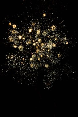 many golden fireworks in dark night sky, isolated on black clipart