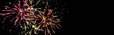 panoramic shot of colorful fireworks in night sky, isolated on black clipart