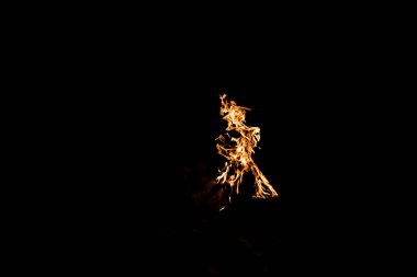 orange flame in bonfire isolated on black clipart