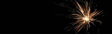 panoramic shot of orange festive firework on party, isolated on black clipart