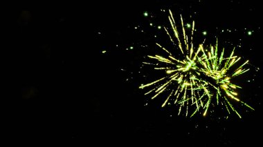 green festive fireworks on party, isolated on black clipart