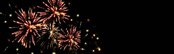 panoramic shot of red festive fireworks in dark night sky, isolated on black