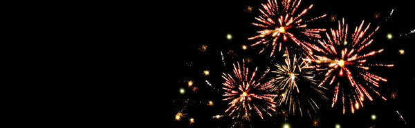 panoramic shot of traditional red fireworks in dark night sky, isolated on black