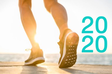 2020 'ye yakın gün ışığında spor ayakkabısı giymiş koşucunun kırpılmış görüntüsü