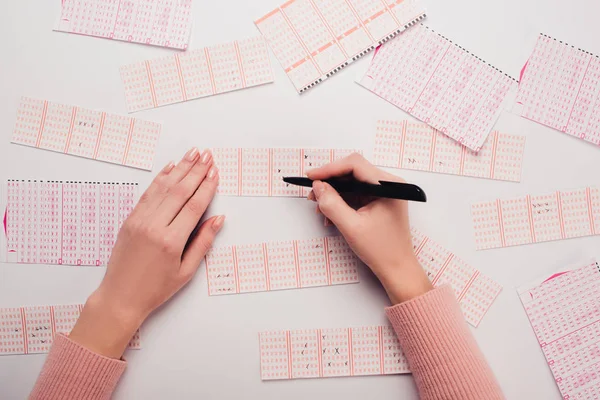 Partial View Woman Marking Numbers Lottery Tickets White Table — Stock Photo, Image
