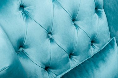 close up view of elegant velour blue armchair with pillow clipart