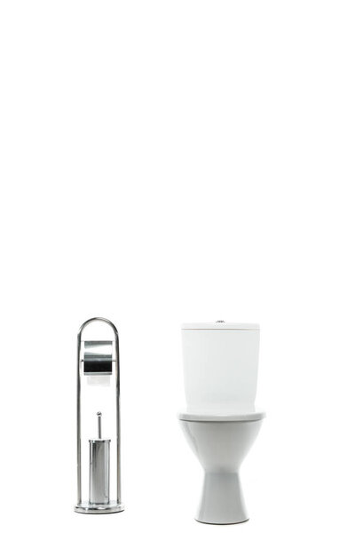 ceramic clean toilet bowl near metal stand with toilet paper and brush isolated on white