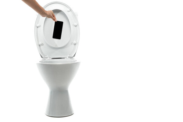 cropped view of woman throwing away smartphone in ceramic clean toilet bowl isolated on white