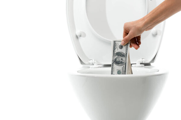 cropped view of woman throwing away money in ceramic clean toilet bowl isolated on white