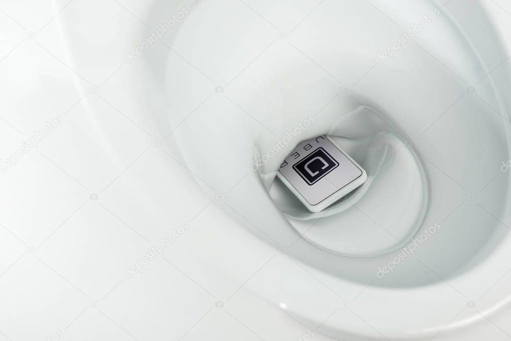 KYIV, UKRAINE - NOVEMBER 7, 2019: close up view of smartphone with uber app in ceramic clean toilet bowl isolated on white