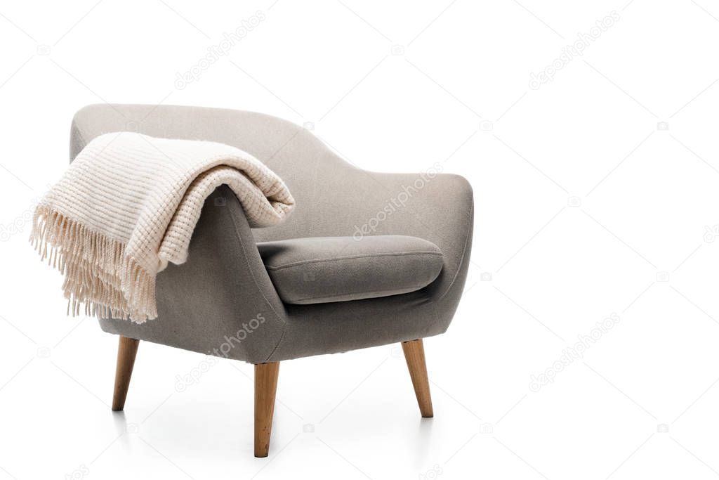 comfortable grey modern armchair with blanket isolated on white