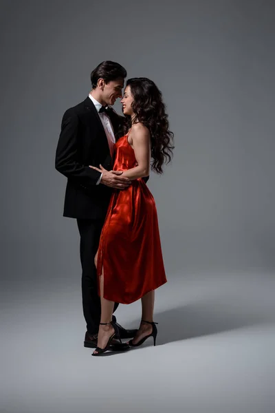 Romantic Couple Suit Red Silk Dress Hugging Looking Each Other — Stock Photo, Image