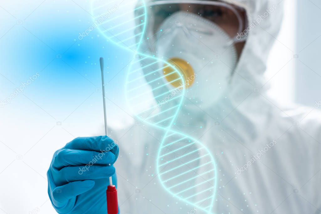 selective focus of scientist doing dna test and standing near illustration 
