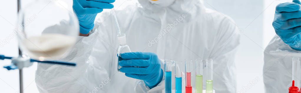 panoramic shot of scientists in latex gloves doing dna test in lab 