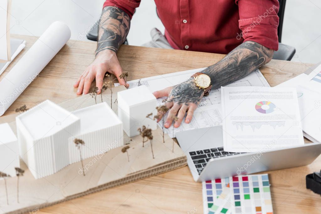 cropped view of virtual reality architect touching model of house 