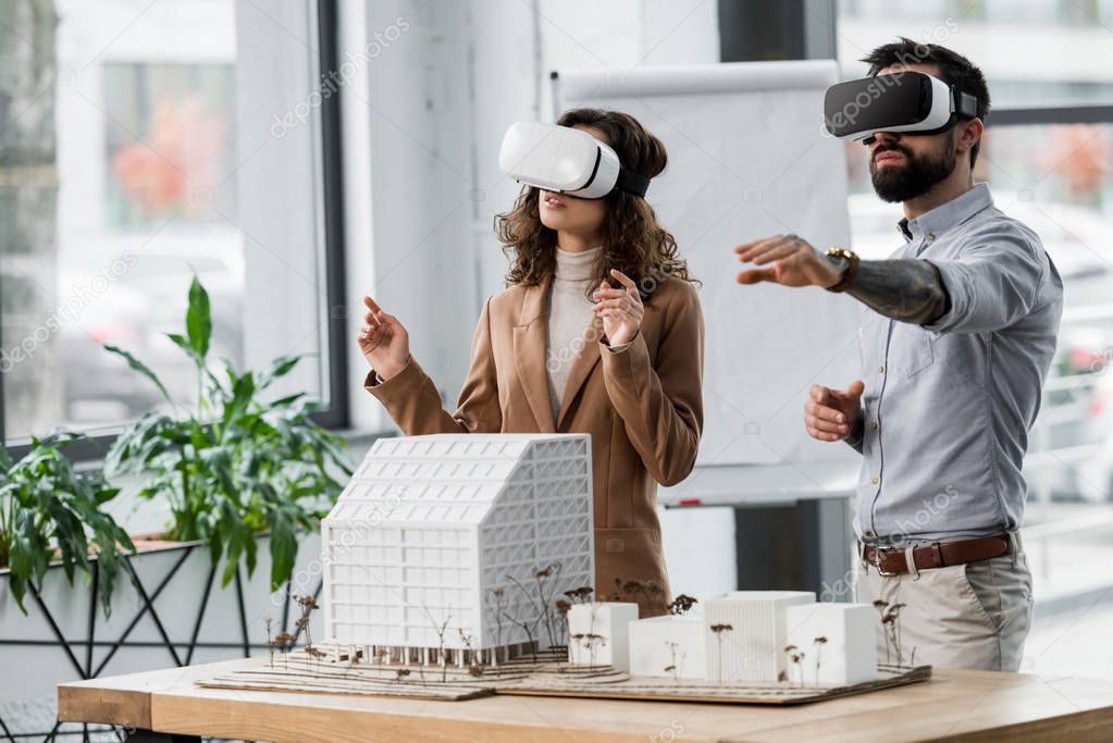 virtual reality architects in virtual reality headsets in office 