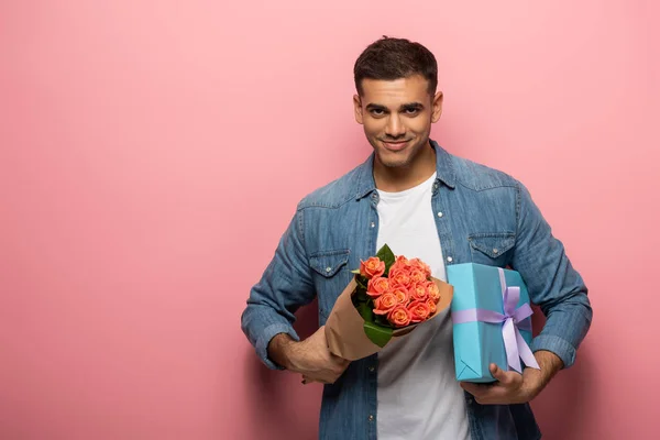 Handsome Man Holding Gift Bouquet Looking Camera Pink Background — Stock Photo, Image