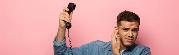 Panoramic Shot Confused Man Holding Telephone Handset Closing Ear Isolated — 스톡 사진