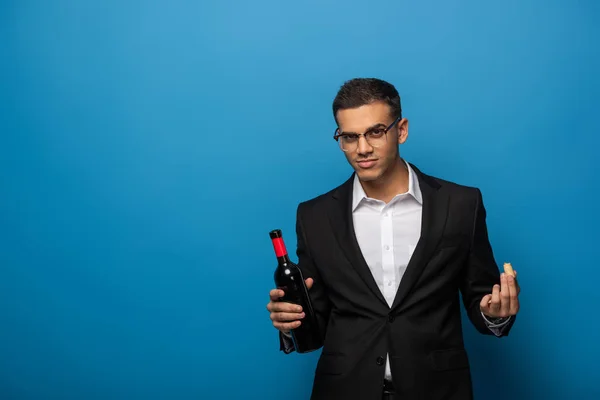 Handsome Businessman Bottle Wine Cork Looking Camera Blue Background — Stock Photo, Image
