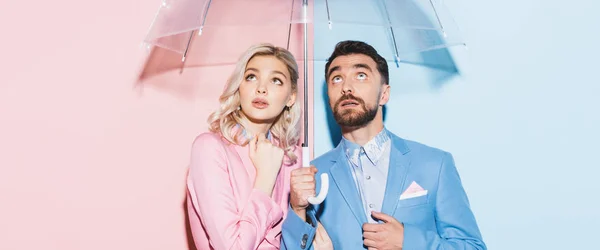 Panoramic Shot Shocked Woman Handsome Man Umbrella Looking Pink Blue — Stock Photo, Image