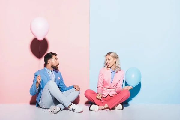 Attractive Woman Sticking Out Tongue Looking Man Balloon Pink Blue — Stock Photo, Image