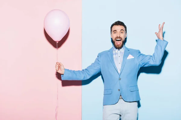 Handsome Smiling Man Holding Balloon Blue Pink Background — Stock Photo, Image