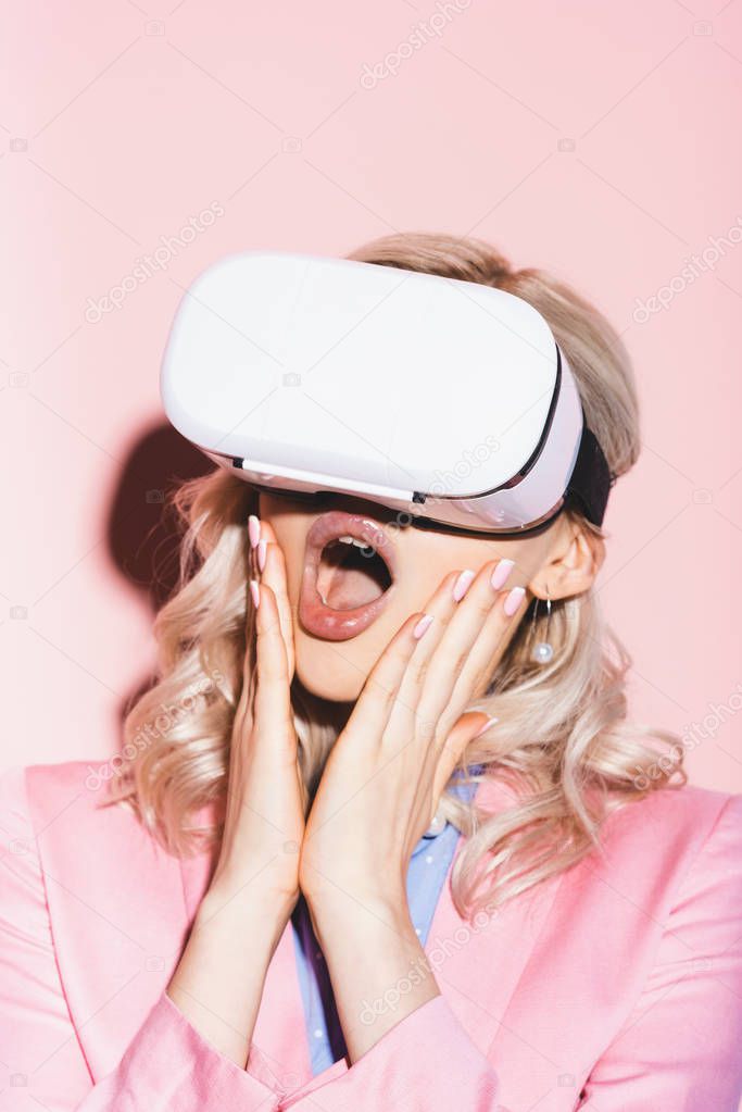 shocked woman in virtual reality headsets on pink background 