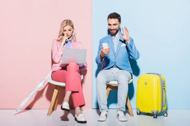 Kadın dizüstü bilgisayar kullanıyor ve gülümseyen adam pembe ve mavi arkaplanda görüntülü arama yapıyor. 