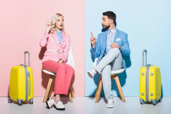 Shocked Woman Handsome Man Showing Idea Gesture Pink Blue Background — Stock Photo, Image