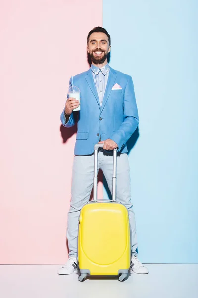Smiling Man Cocktail Holding Travel Bag Pink Blue Background — Stock Photo, Image