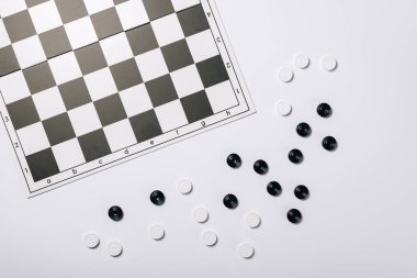 Top view of chessboard and checkers isolated on white clipart