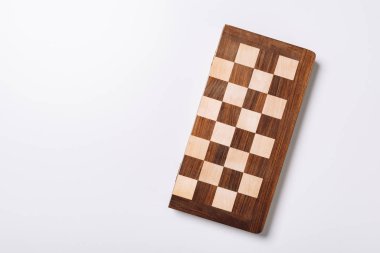 Top view of wooden checkerboard on white background with copy space clipart
