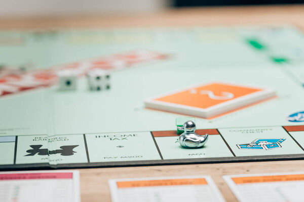 KYIV, UKRAINE - NOVEMBER 15, 2019: Selective focus of playing figure on monopoly game