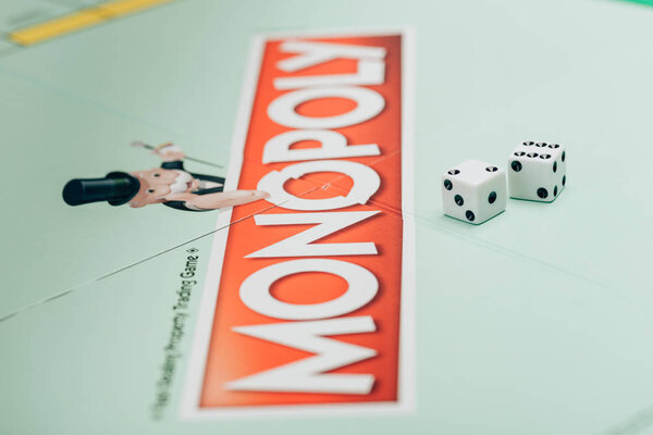 KYIV, UKRAINE - NOVEMBER 15, 2019: Selective focus of two dices on monopoly board game 
