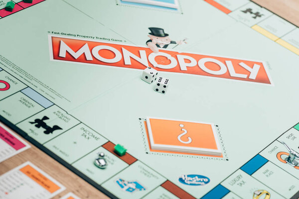 KYIV, UKRAINE - NOVEMBER 15, 2019: Selective focus of monopoly game with dices and cards on table