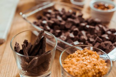 selective focus of chocolate sticks in glass near chocolate cubes  clipart