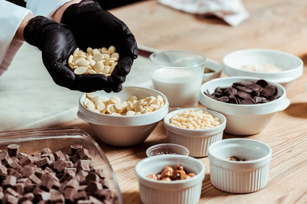 Selective Focus Chocolatier Black Latex Gloves Holding White Chocolate Chips — Stock Photo, Image