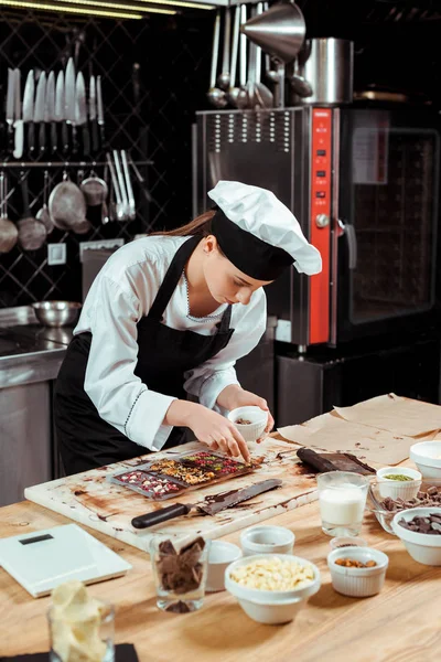 Chocolatier Atraente Avental Olhando Para Barras Chocolate Escuro — Fotografia de Stock